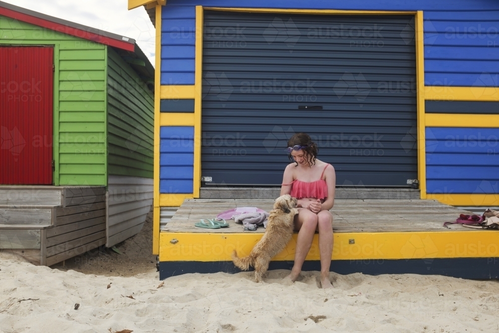 Girl at colourful beachbox - Australian Stock Image