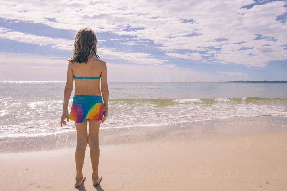 girl at the beach in rainbow togs - Australian Stock Image