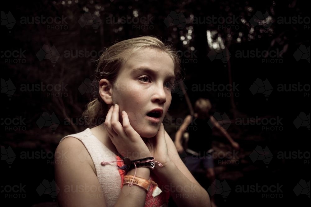 Girl at the creek, upset. - Australian Stock Image