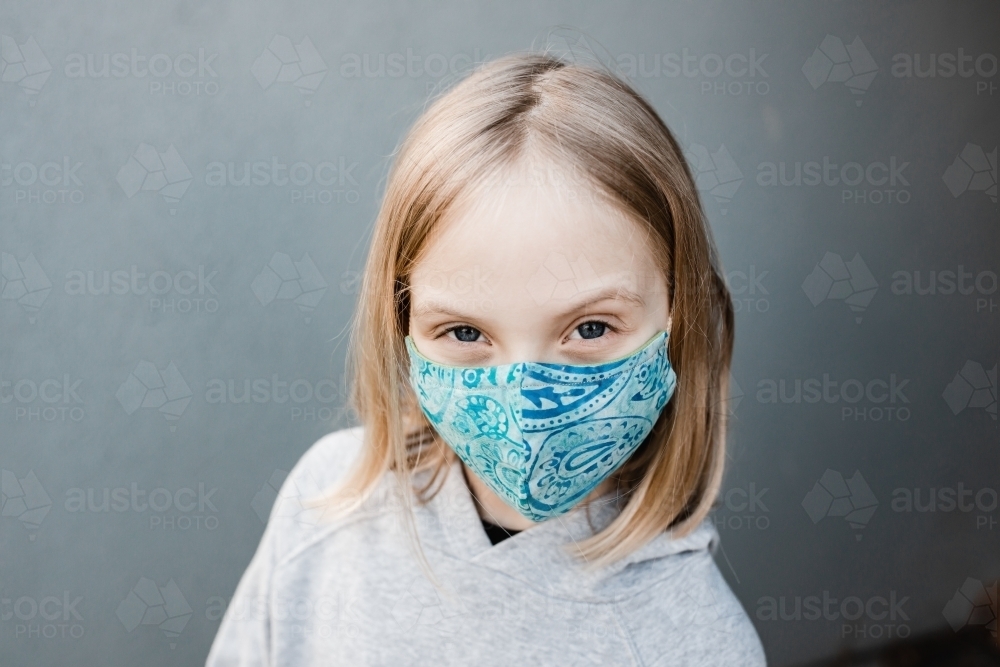 girl child wearing fabric masks during the corona COVID-19 pandemic, masks are now compulsory. - Australian Stock Image