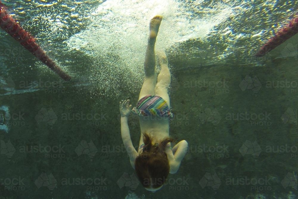Girl diving in a pool - Australian Stock Image