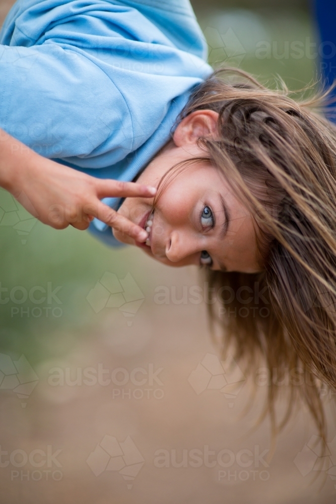 Girl hanging upside down - Australian Stock Image
