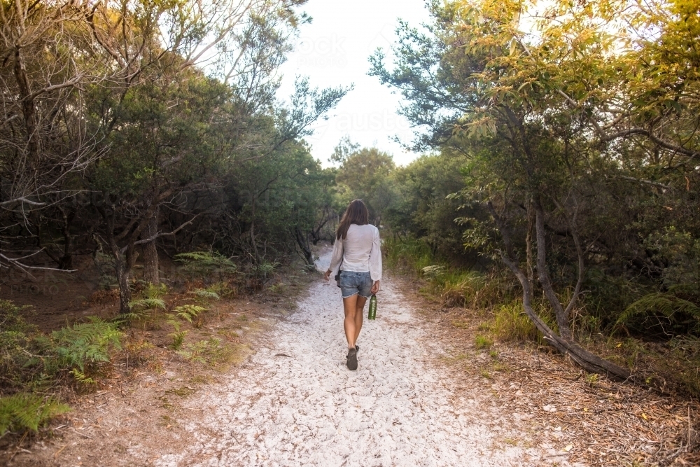 Girl hiking to beach - Australian Stock Image