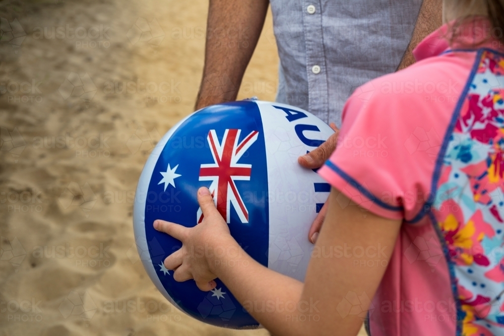 Girl holding ball with Australian Flag on it - Australian Stock Image