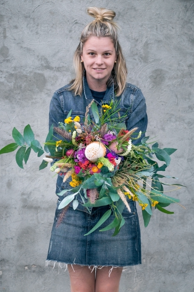 Girl holding  bunch of wild flowers - Australian Stock Image