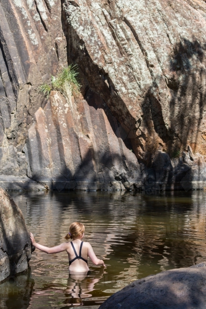 Girl in a waterhole in inland Australia - Australian Stock Image