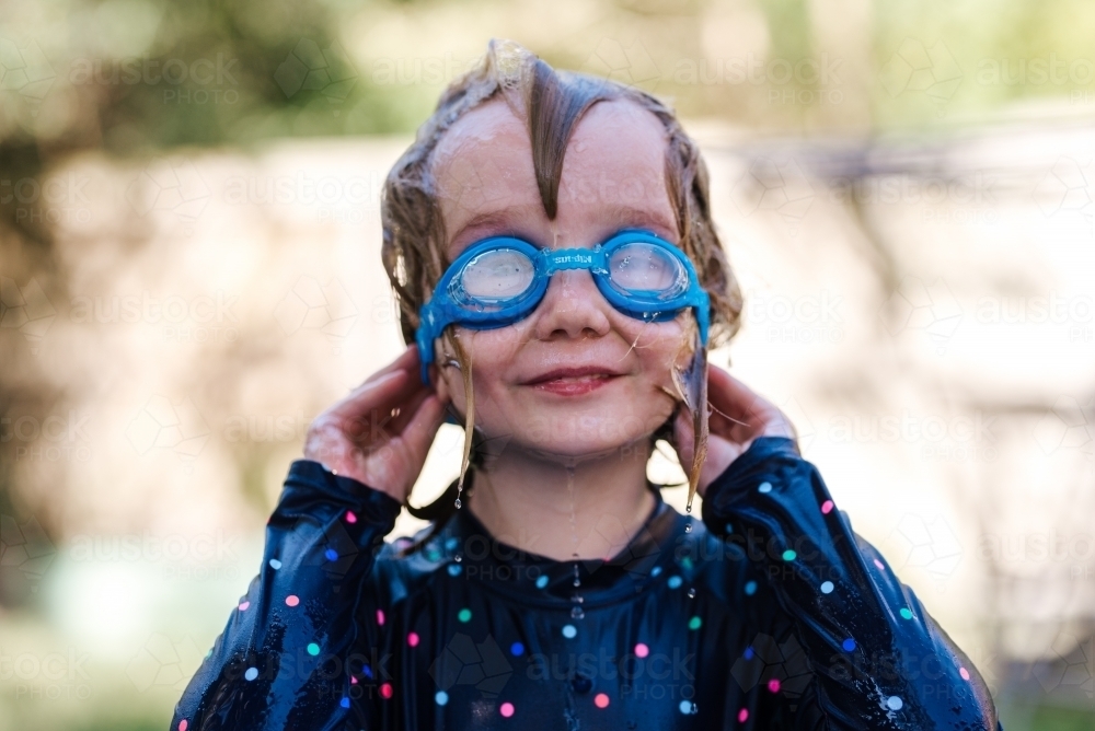 Girl in goggles, water play - Australian Stock Image