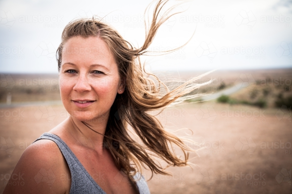 Girl in outback with hair blowing in the wind - Australian Stock Image