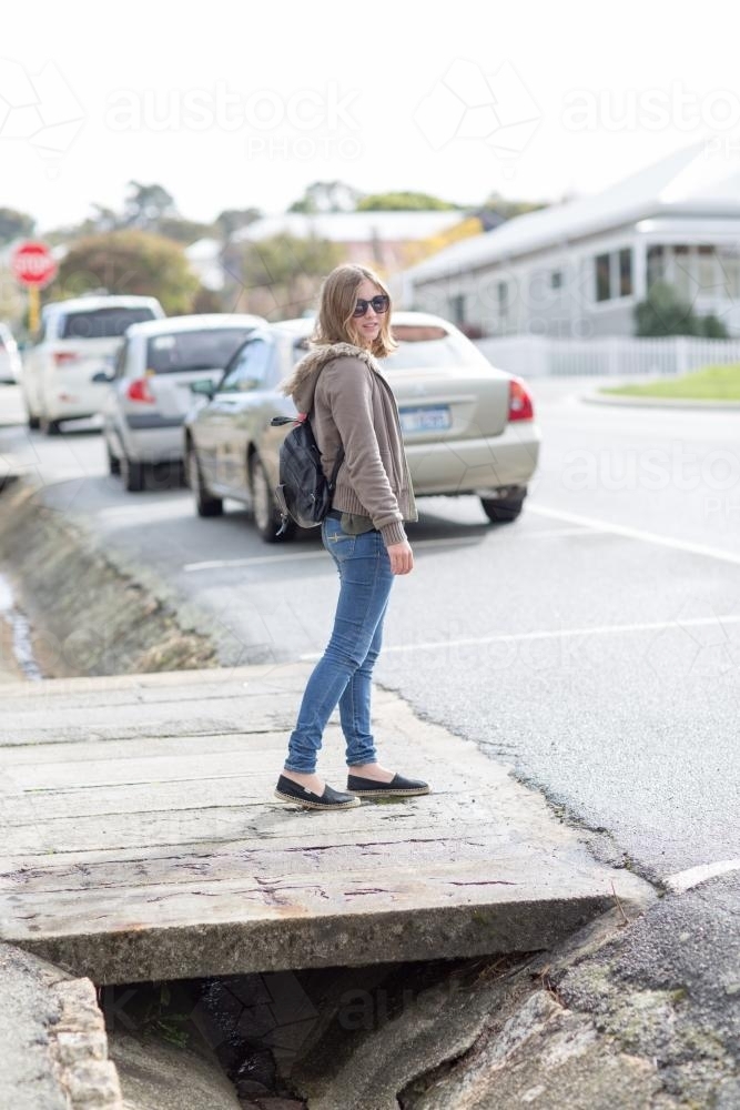 Girl in street with parked cars - Australian Stock Image
