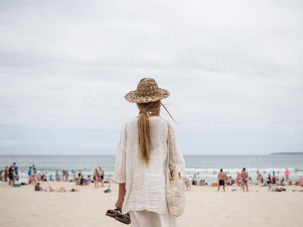 Girl looking on to busy Bondi beach - Australian Stock Image