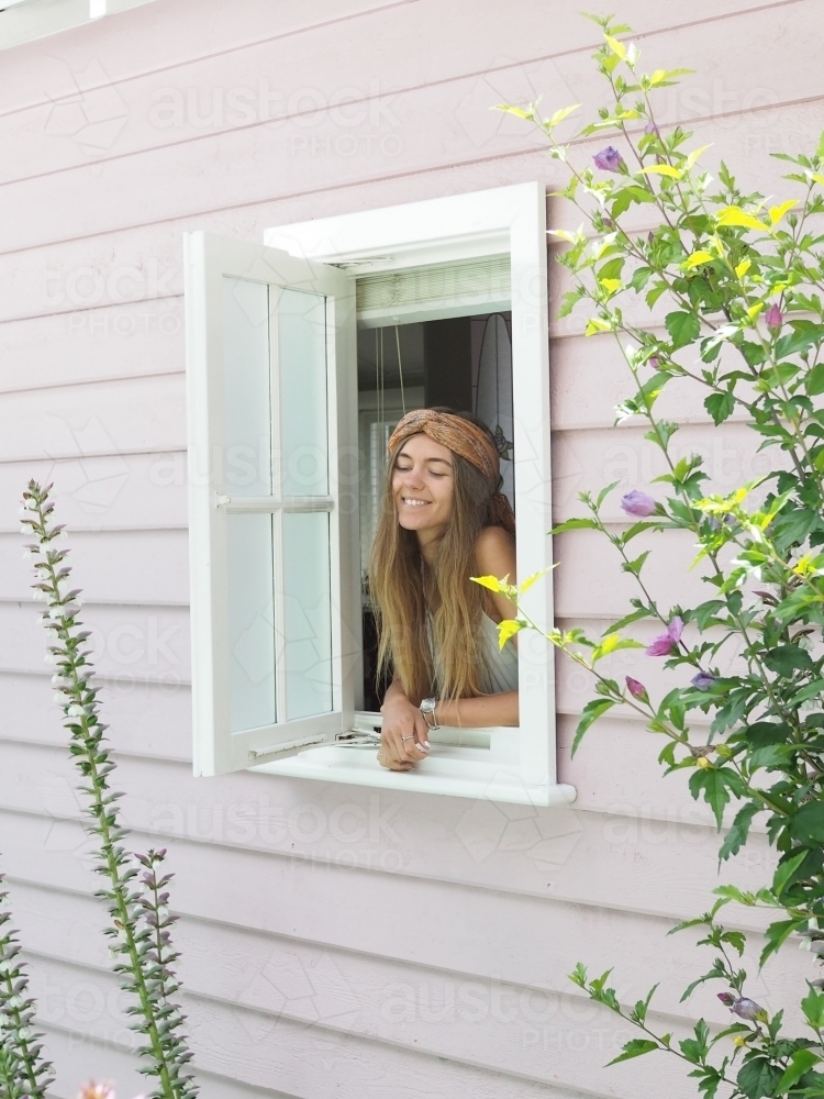 Girl looking out of window - Australian Stock Image