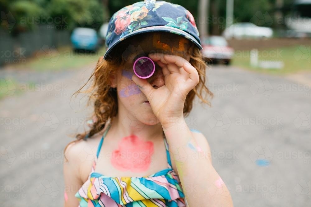 Girl looking through a kaleidoscope - Australian Stock Image