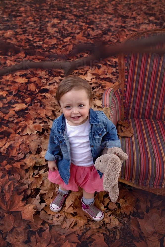 Girl Looking Up in Autumn Leaves - Australian Stock Image