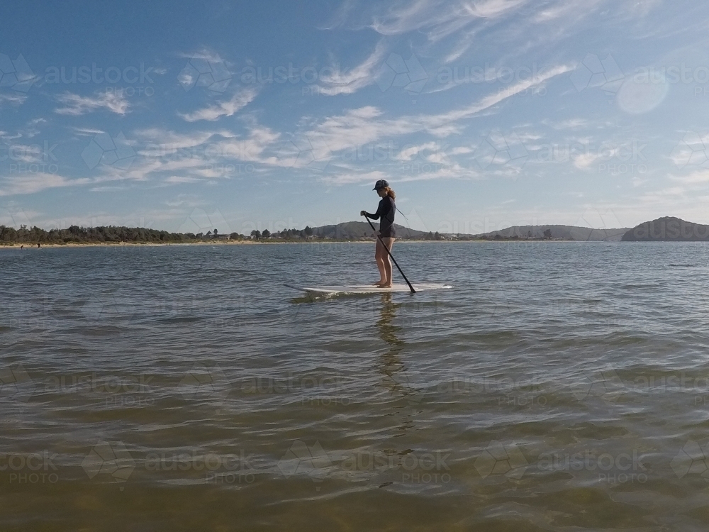 Girl on a stand up paddle board - Australian Stock Image