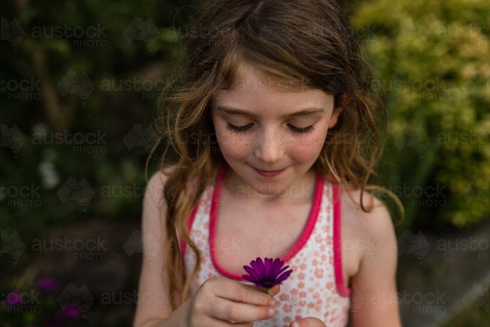 Girl outside with flowers - Australian Stock Image