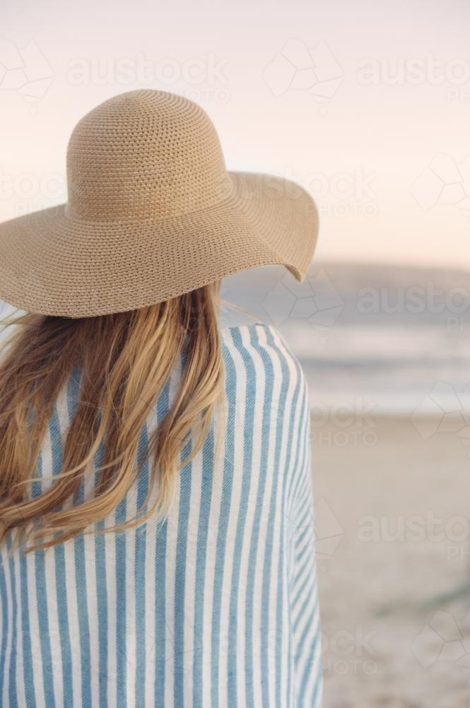 Girl overlooking the ocean at sunset - Australian Stock Image