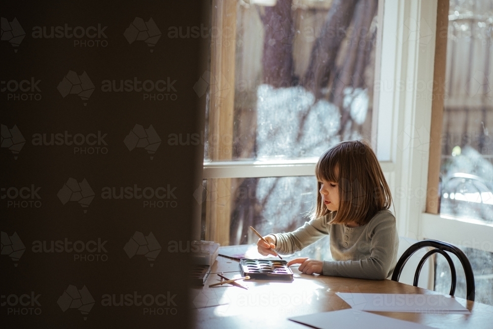 Girl painting with watercolour - Australian Stock Image