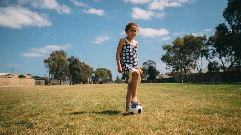 Girl playing soccer on the grass - Australian Stock Image