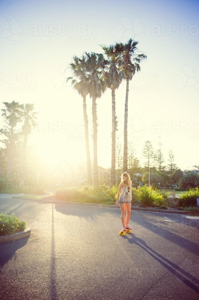Girl Riding a Skateboard at Sunset - Australian Stock Image