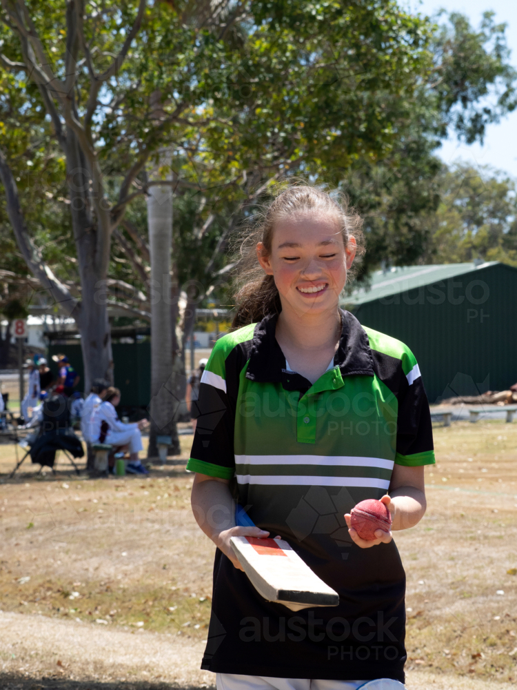 Girl's team female cricket player getting ready to play smiling - Australian Stock Image
