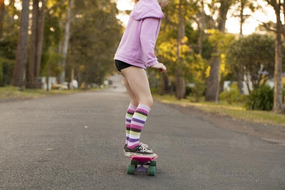 Girl skateboarding in a street - Australian Stock Image