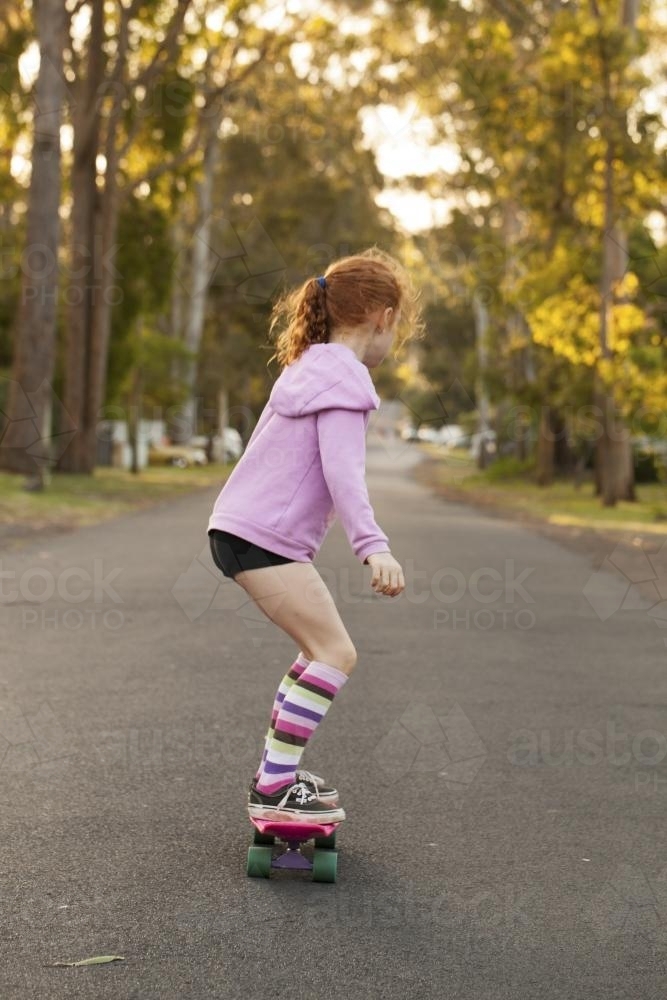Girl skateboarding in a street - Australian Stock Image
