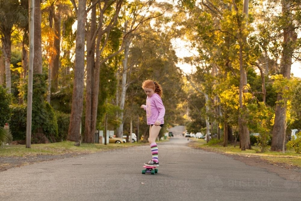Girl skateboarding in a street - Australian Stock Image