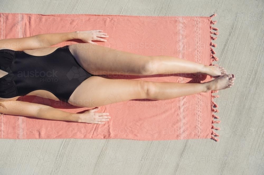 Girl sunbaking on turkish towel - Australian Stock Image