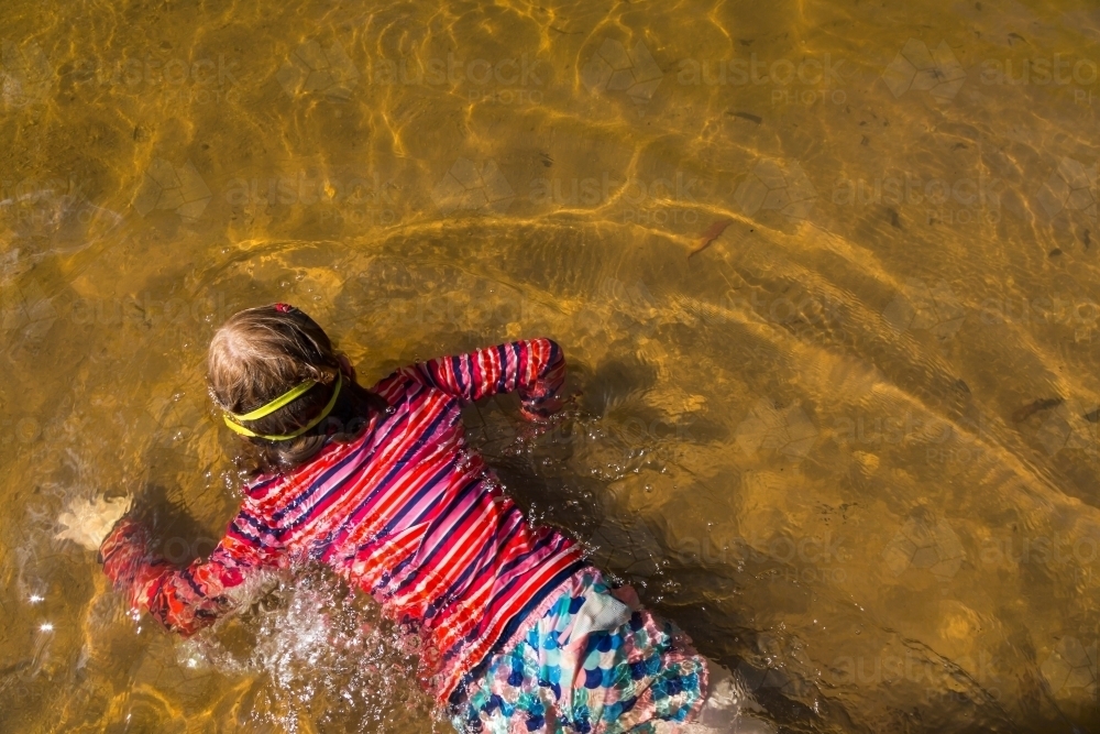 Girl swimming in a waterhole taken from above - Australian Stock Image