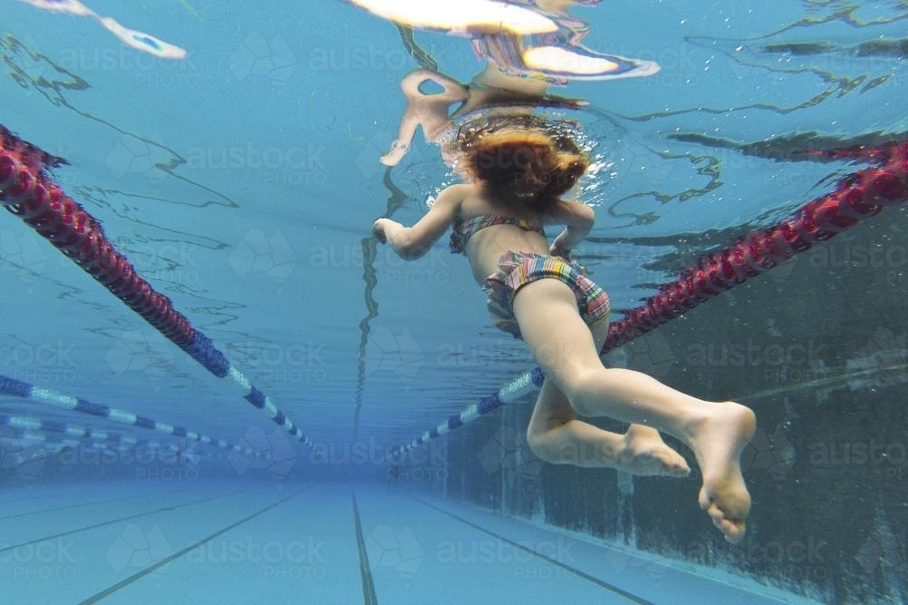 Girl swimming underwater - Australian Stock Image