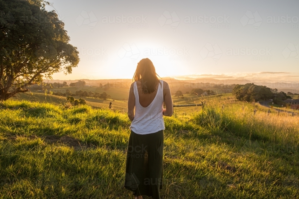 Girl taking in the last light of the day - Australian Stock Image