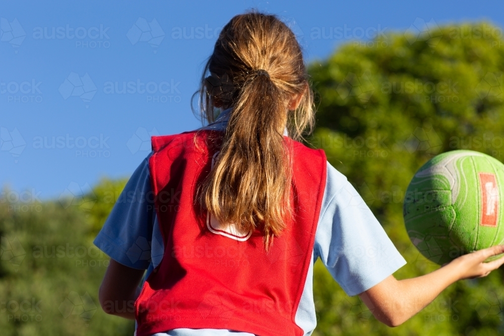 Image of Girl throwing netball from behind - Austockphoto