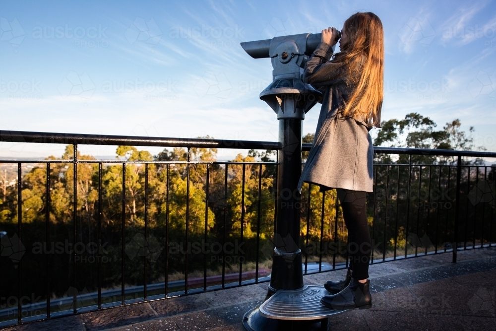 girl using a lookout telescope - Australian Stock Image