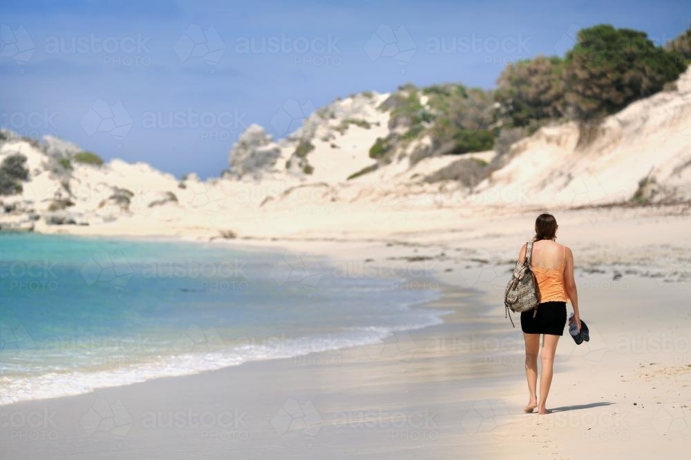 Girl walking along the beach - Australian Stock Image