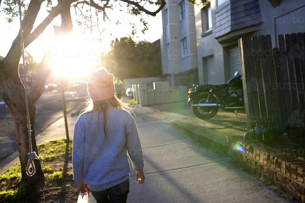 Girl walking away down a footpath - Australian Stock Image