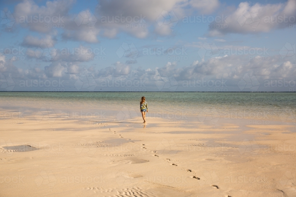 girl walking away on the beach - Australian Stock Image