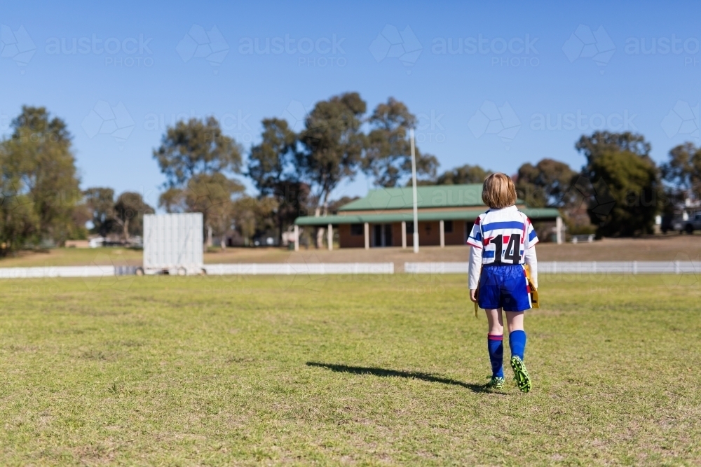 girl wearing rugby league jersey at an oval - Australian Stock Image