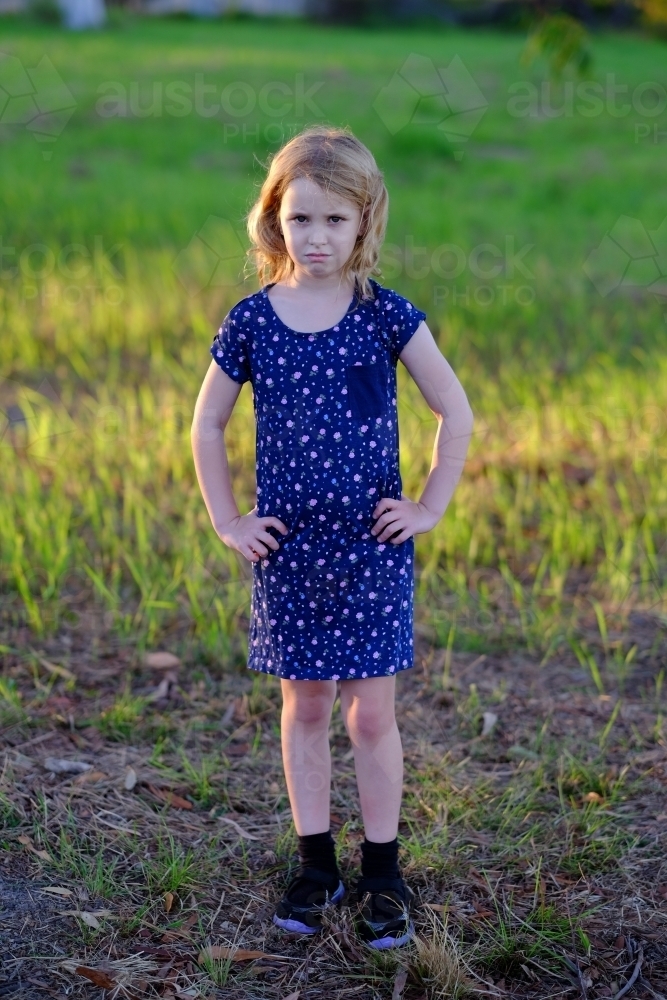 Girl with a frown and hands on hips - Australian Stock Image