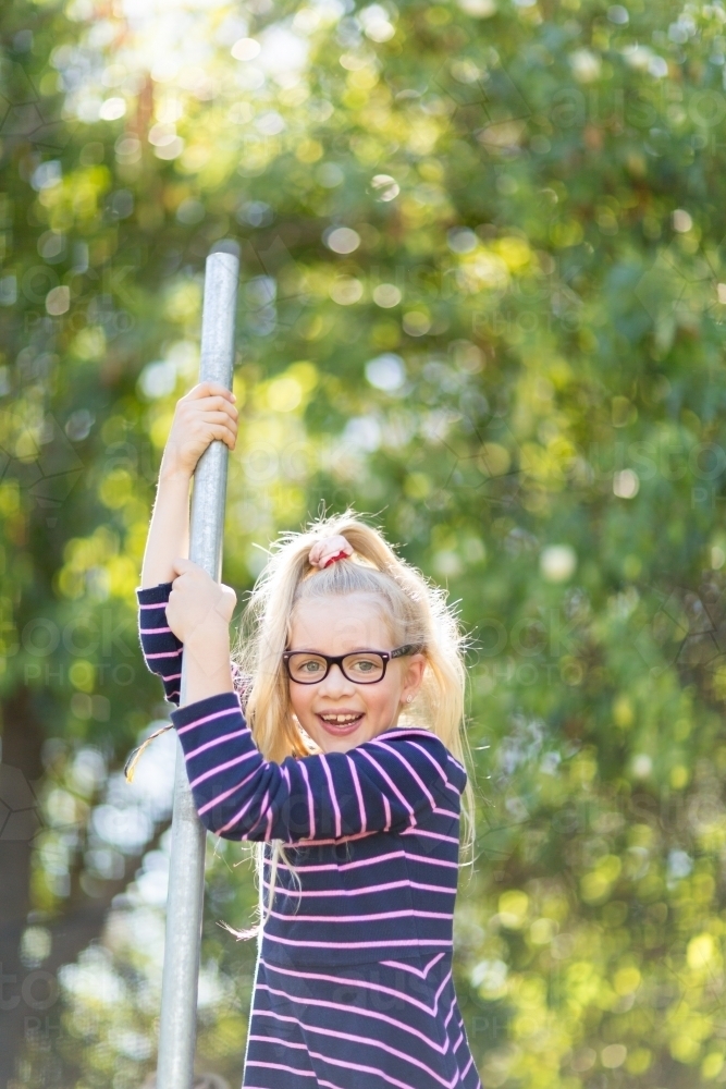 Girl with blonde ponytail outside in park - Australian Stock Image
