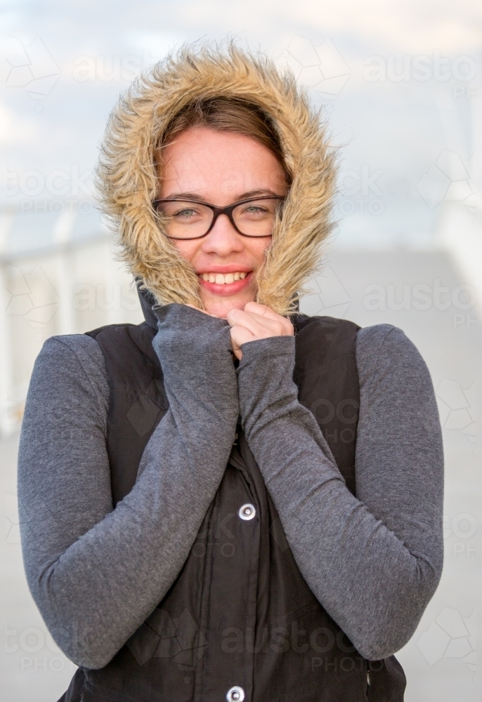 Girl with fur trimmed hood on a cold day - Australian Stock Image