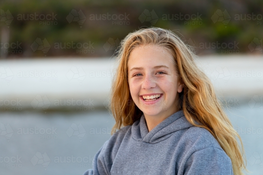 Girl with long hair head and shoulders looking at camera - Australian Stock Image