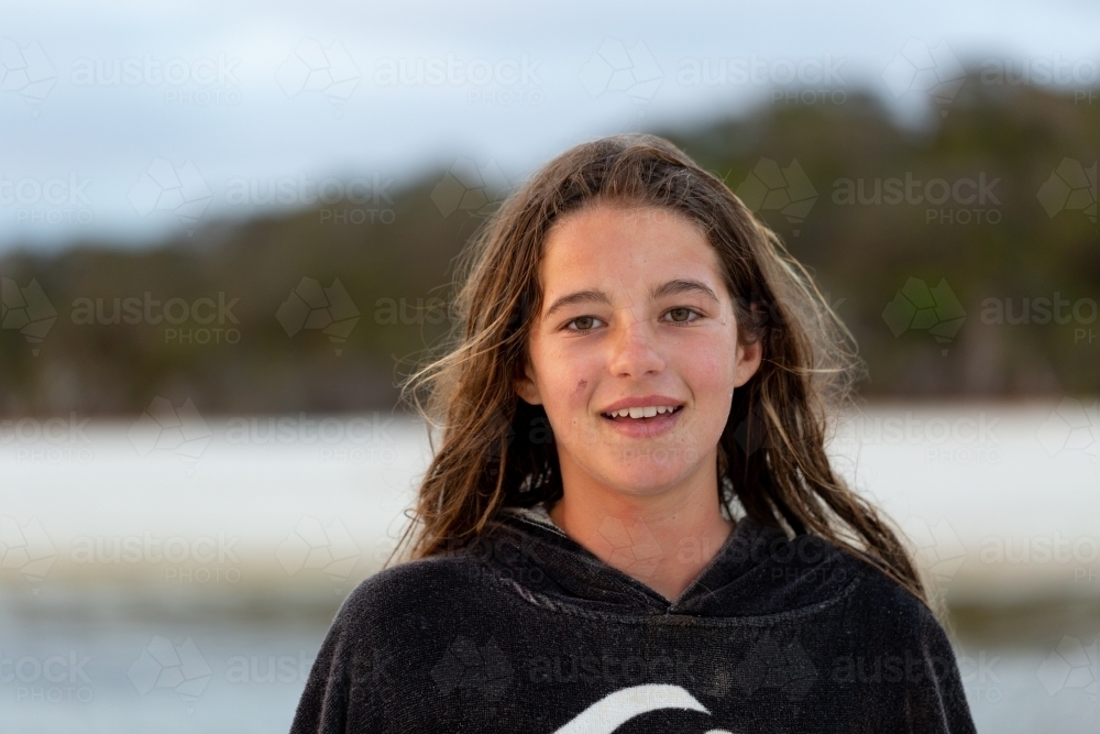 Girl with long messy hair looking at camera - Australian Stock Image