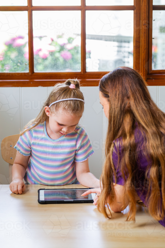 Girl with speech disability caused by lymphatic malformation talking with speech-language pathologis - Australian Stock Image