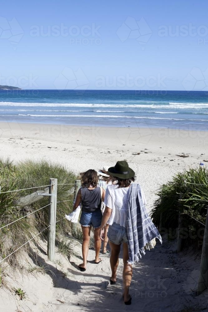 Girls on pathway toward the beach - Australian Stock Image