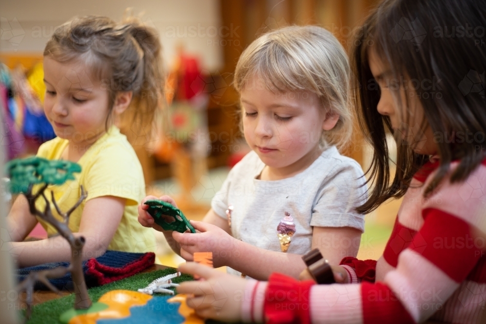 Girls playing with a plastic tree - Australian Stock Image
