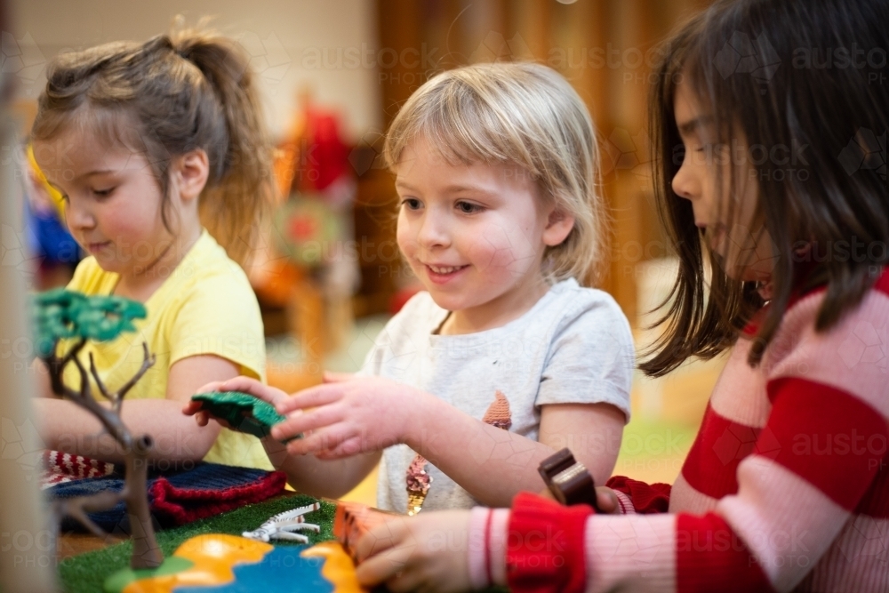 Girls playing with a plastic tree - Australian Stock Image