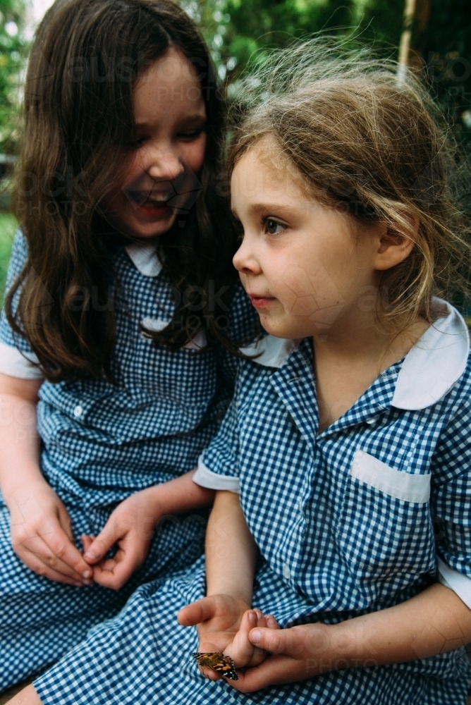 Girls sitting together in school uniform - Australian Stock Image