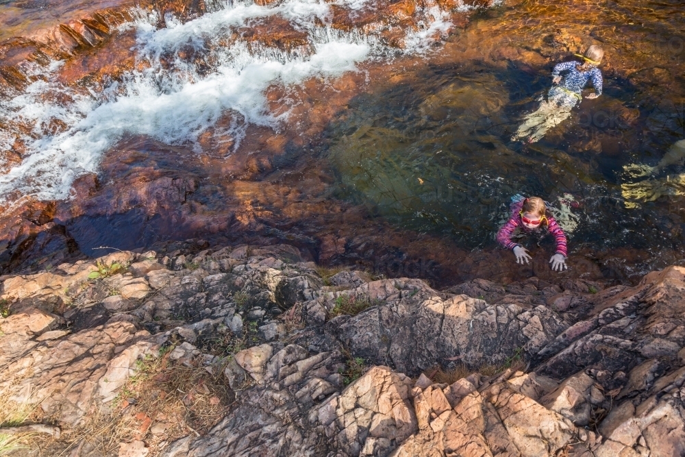 girls  swimming in a waterhole in Litchfield national park, northern territory - Australian Stock Image