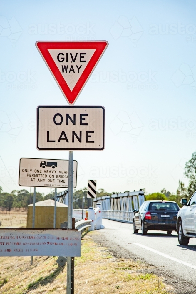Give way one lane road sign before Bulga Bridge - Australian Stock Image
