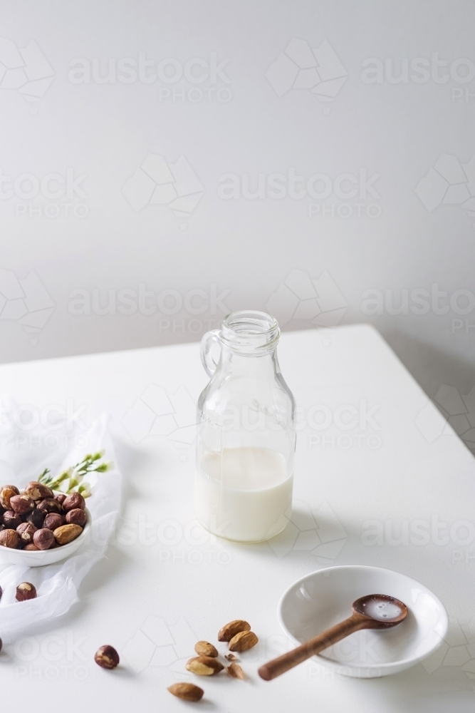 Glass bottle filled with nut milk - Australian Stock Image